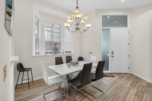 a view of a dining room with furniture and chandelier