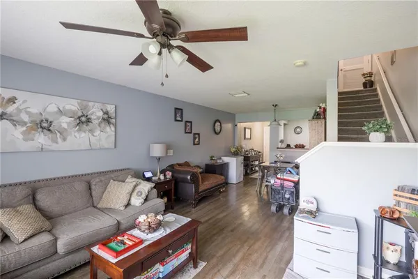 a living room with furniture and wooden floor