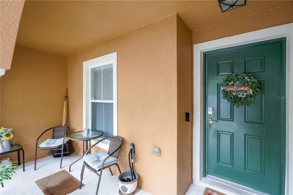 a balcony with table and chairs