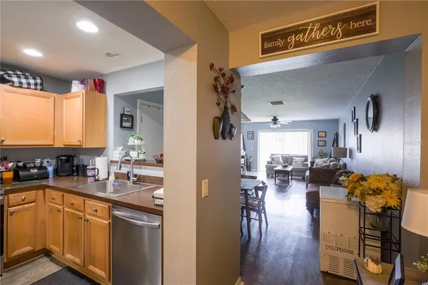 a kitchen with sink refrigerator and cabinets