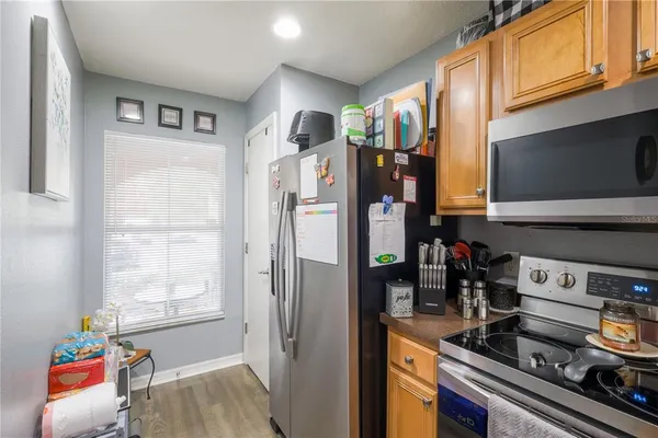 a kitchen with stainless steel appliances granite countertop a refrigerator and a stove top oven