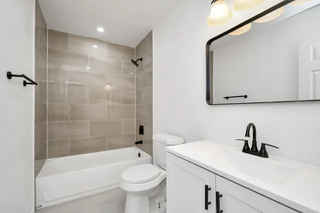 a bathroom with a sink a toilet and bathtub