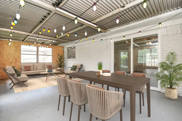 a view of a dining room and livingroom with furniture wooden floor and a potted plant