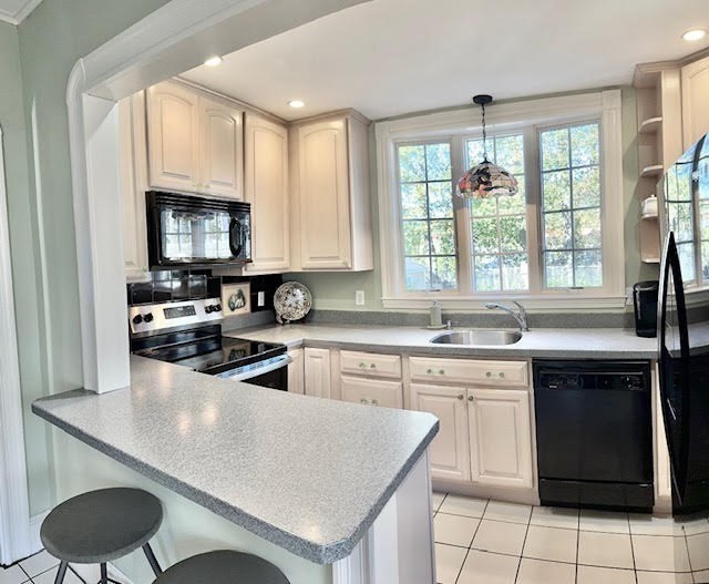 76 Stetson Avenue Swampscott, MA 01907 - Photo 6 of 20 a kitchen with a sink stove and cabinets