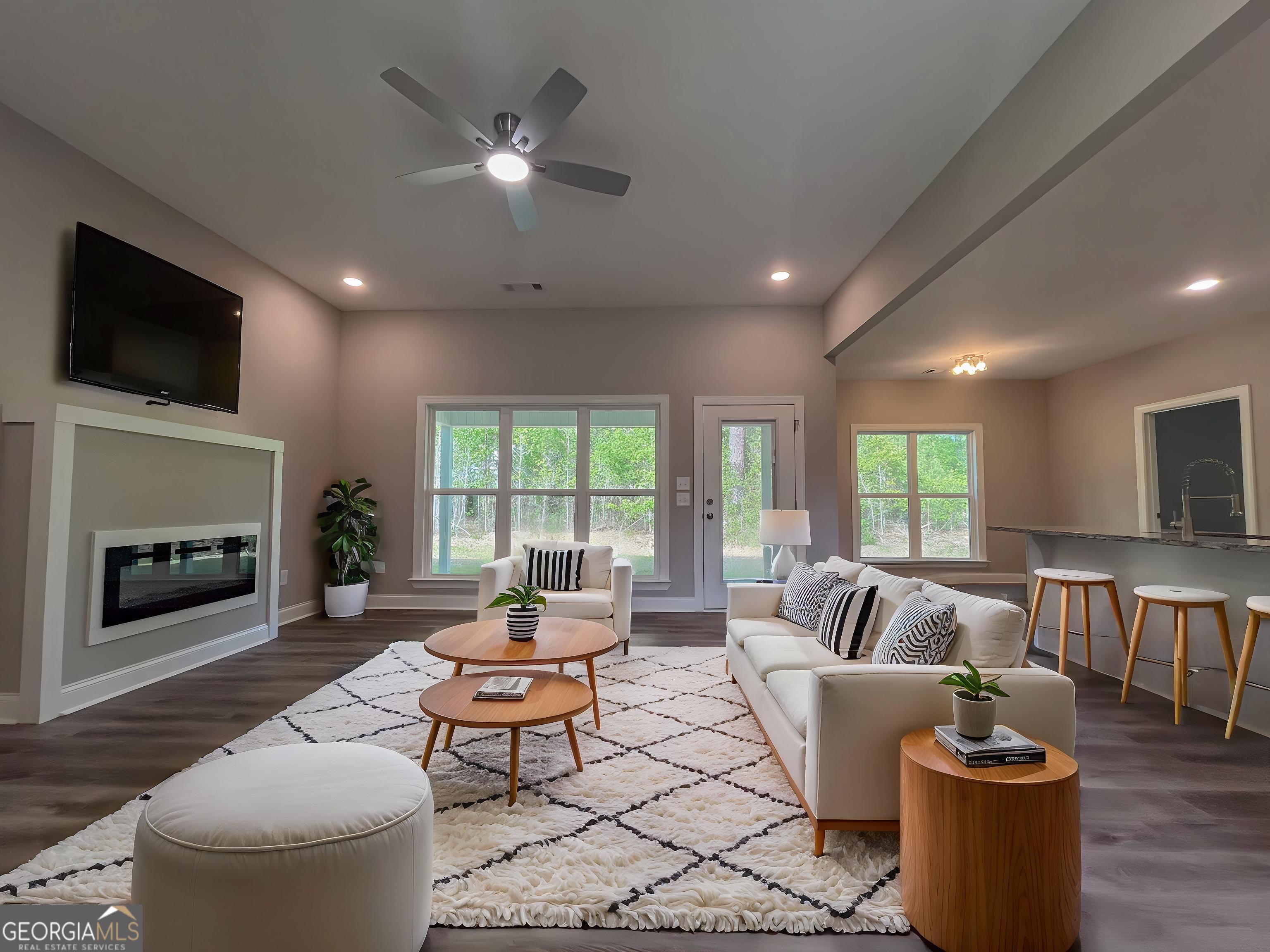 711 Flanders Lane Dublin, GA 31021 - Photo 5 of 49 a living room with furniture a fireplace and a flat screen tv