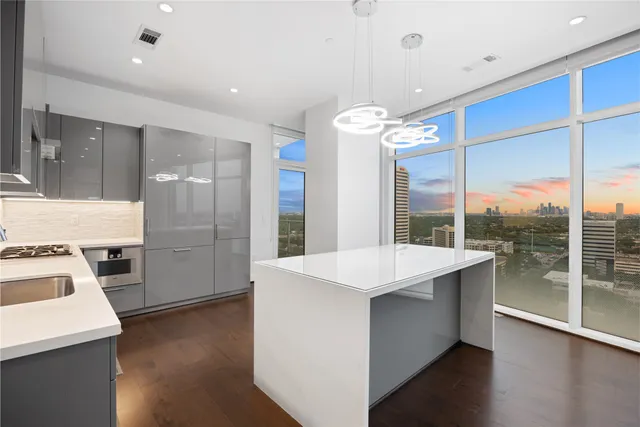 a kitchen with a sink a stove and cabinets