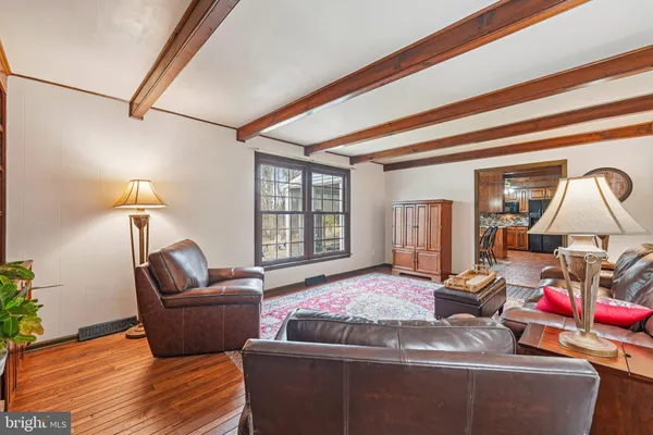 a large kitchen with granite countertop lots of counter top space dining table and stainless steel appliances