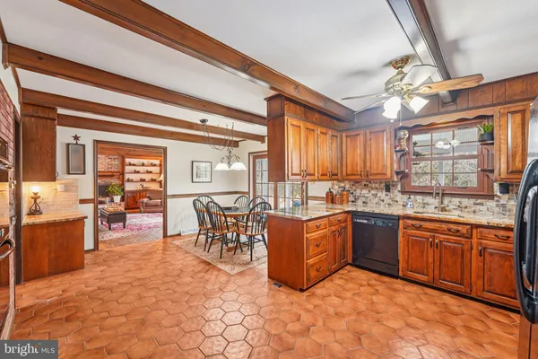 a kitchen with stainless steel appliances granite countertop a refrigerator a sink a stove and island