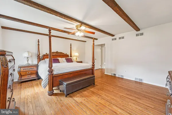 a bedroom with a large bed and a window