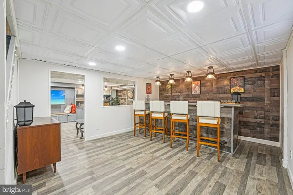a living room with patio furniture and a floor to ceiling window