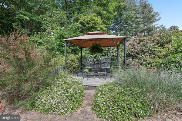 a view of a garden with flowers and trees