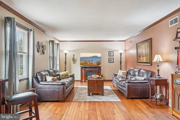 a living room with furniture window and wooden floor
