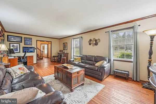 a living room with furniture and painting on the wall