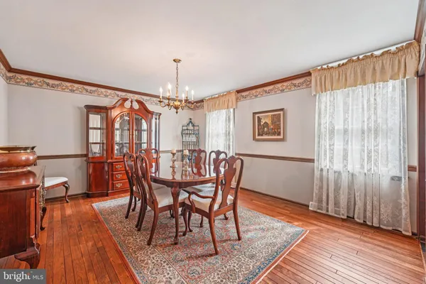 a dining room with furniture and wooden floor
