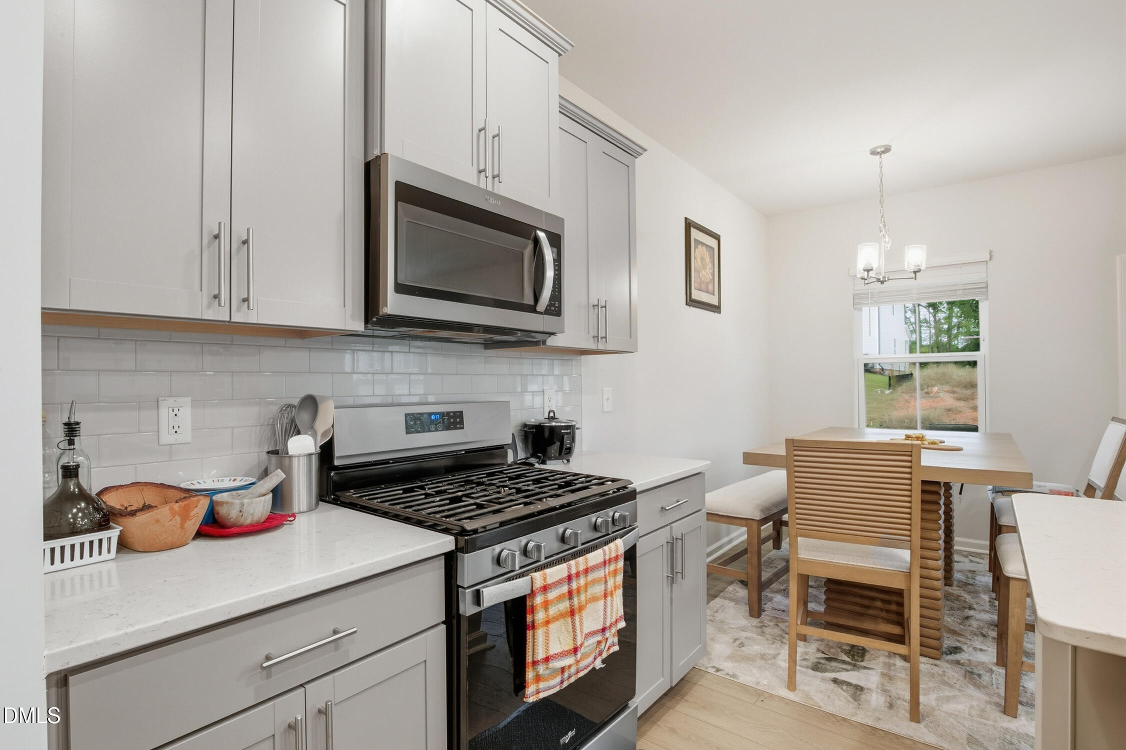 732 Denburn Place Raleigh, NC 27603 - Photo 2 of 12 a kitchen with stainless steel appliances a stove a sink cabinets and a microwave