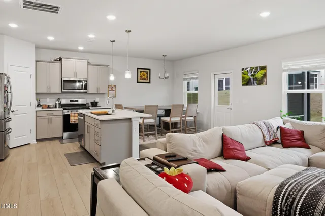 a living room with furniture and kitchen view
