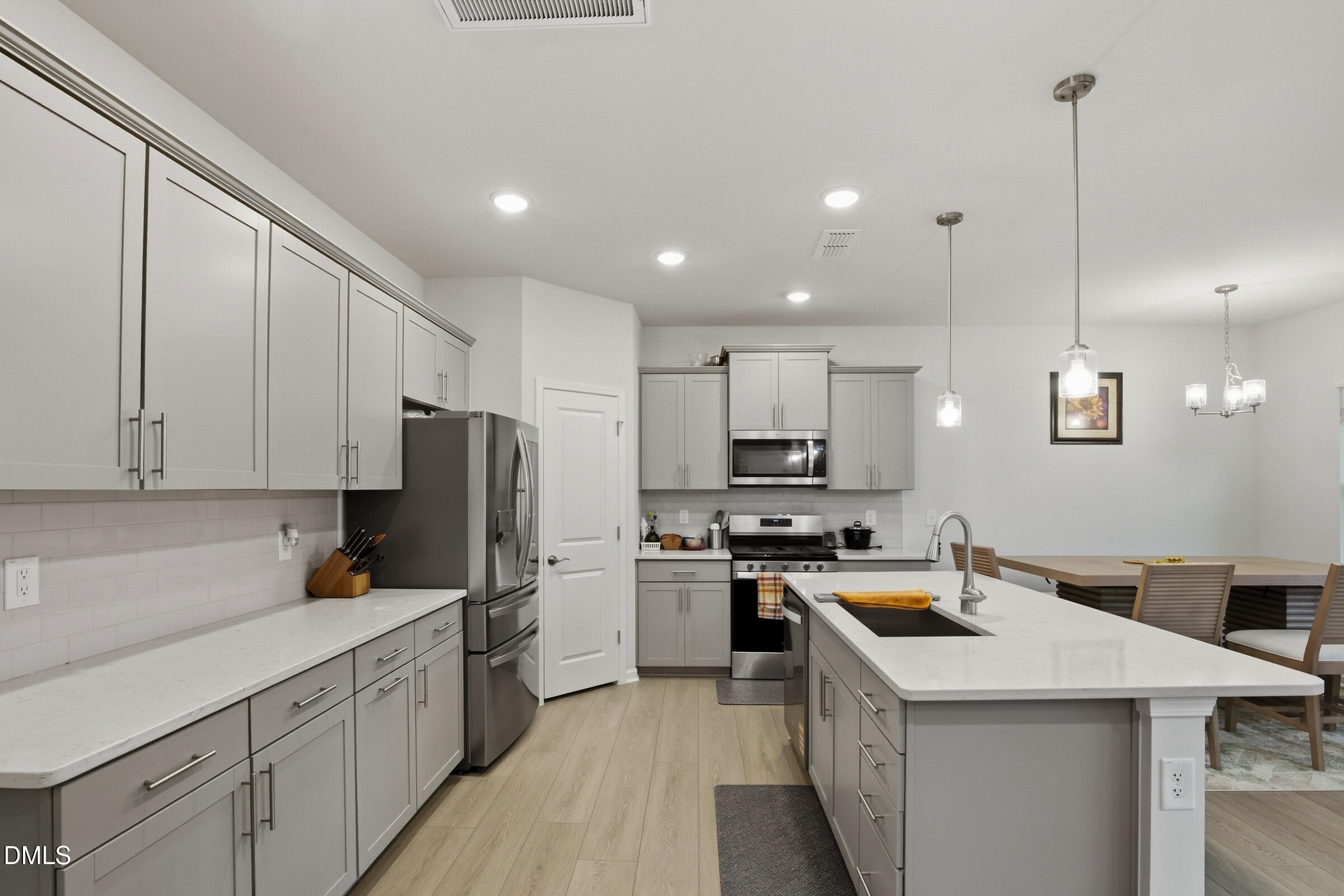 732 Denburn Place Raleigh, NC 27603 - Photo 7 of 12 a kitchen with a sink a stove a refrigerator and cabinets