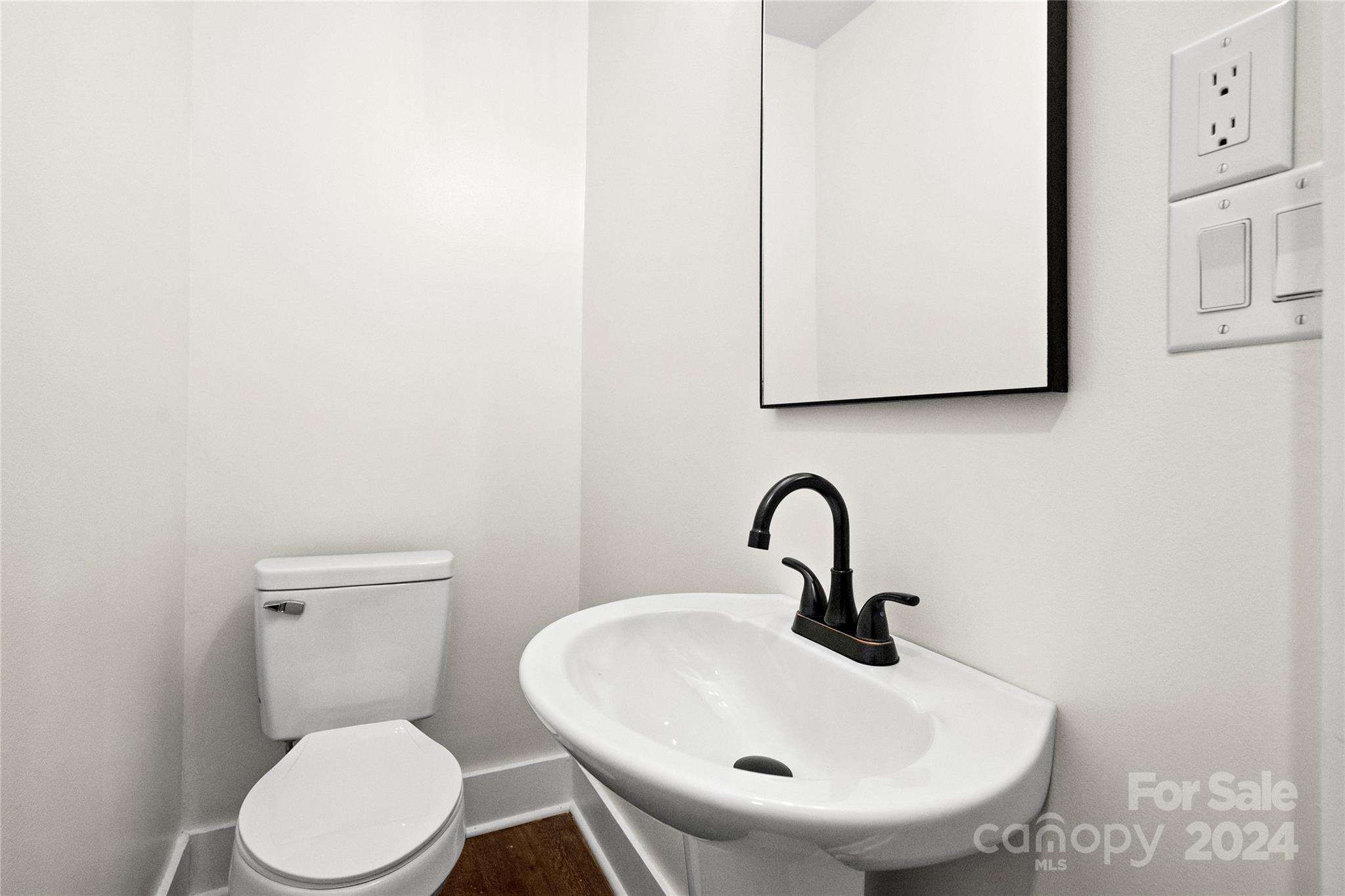 1660 Willowbrook Drive Fort Mill, SC 29708 - Photo 16 of 29 a bathroom with a toilet sink and mirror