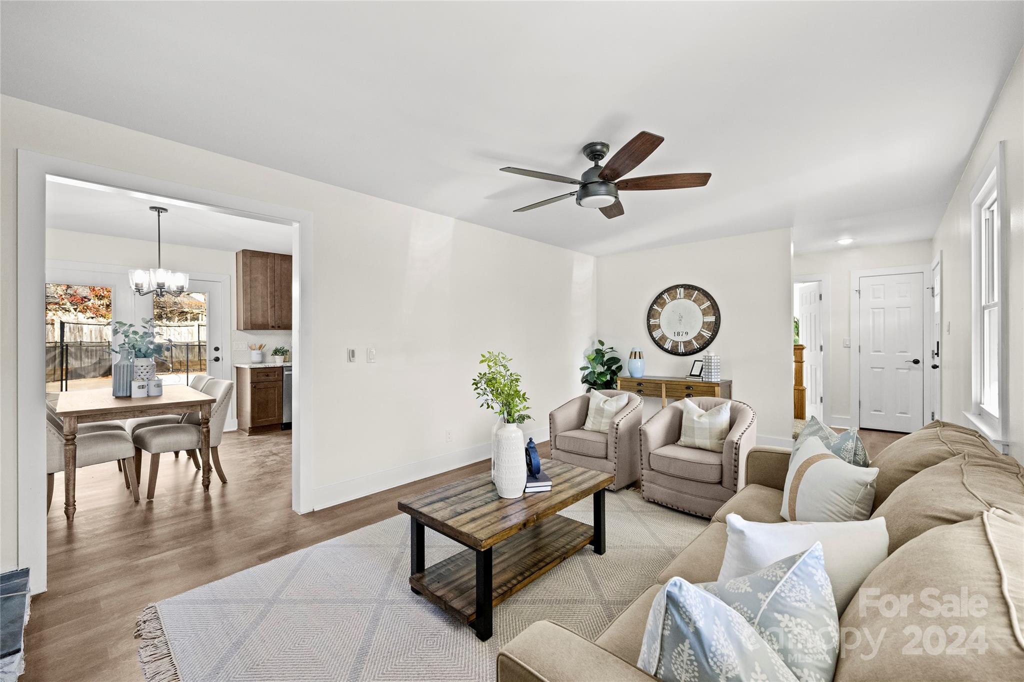 1660 Willowbrook Drive Fort Mill, SC 29708 - Photo 6 of 29 a living room with furniture a window and a clock