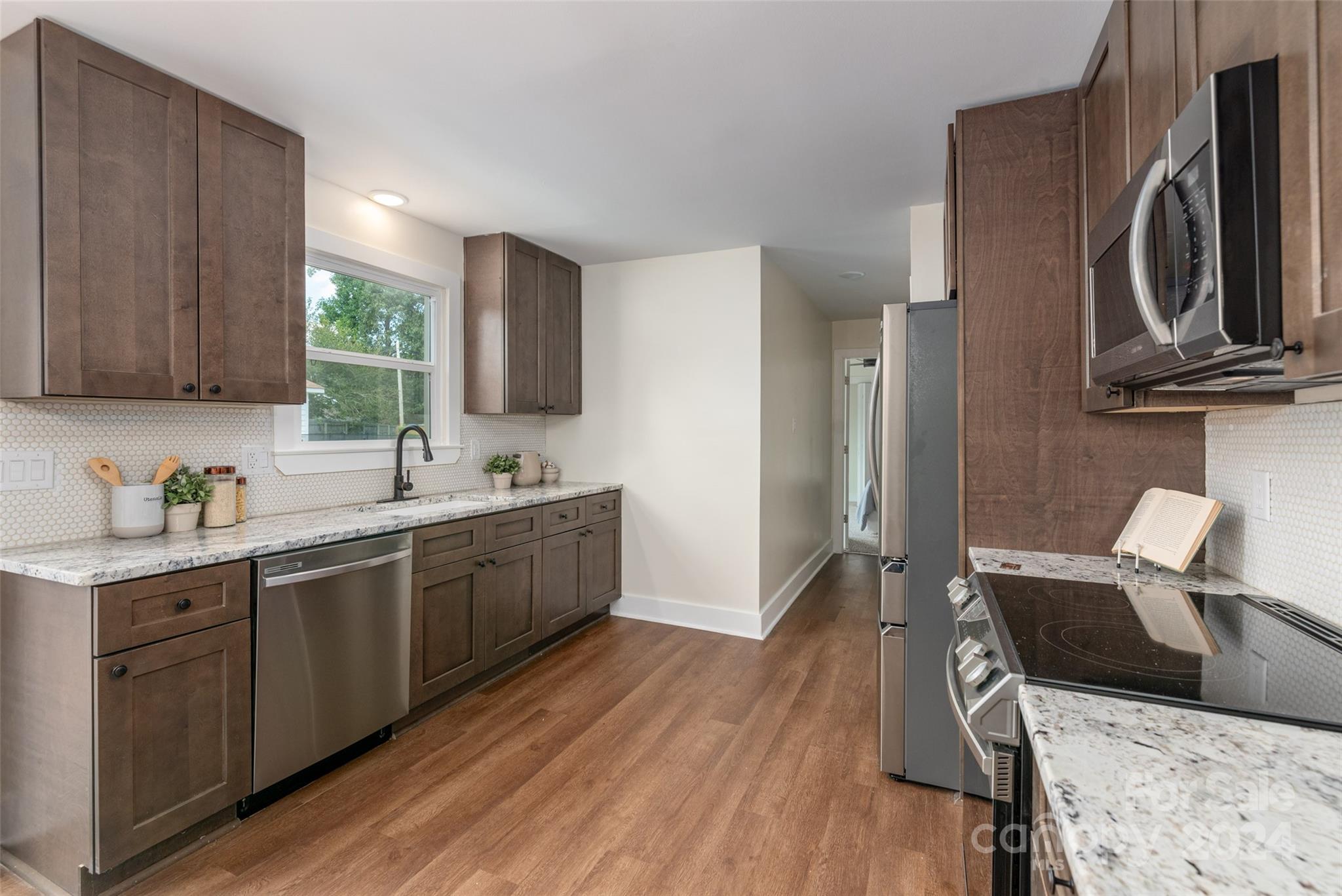1660 Willowbrook Drive Fort Mill, SC 29708 - Photo 8 of 29 a kitchen with a sink cabinets and wooden floor