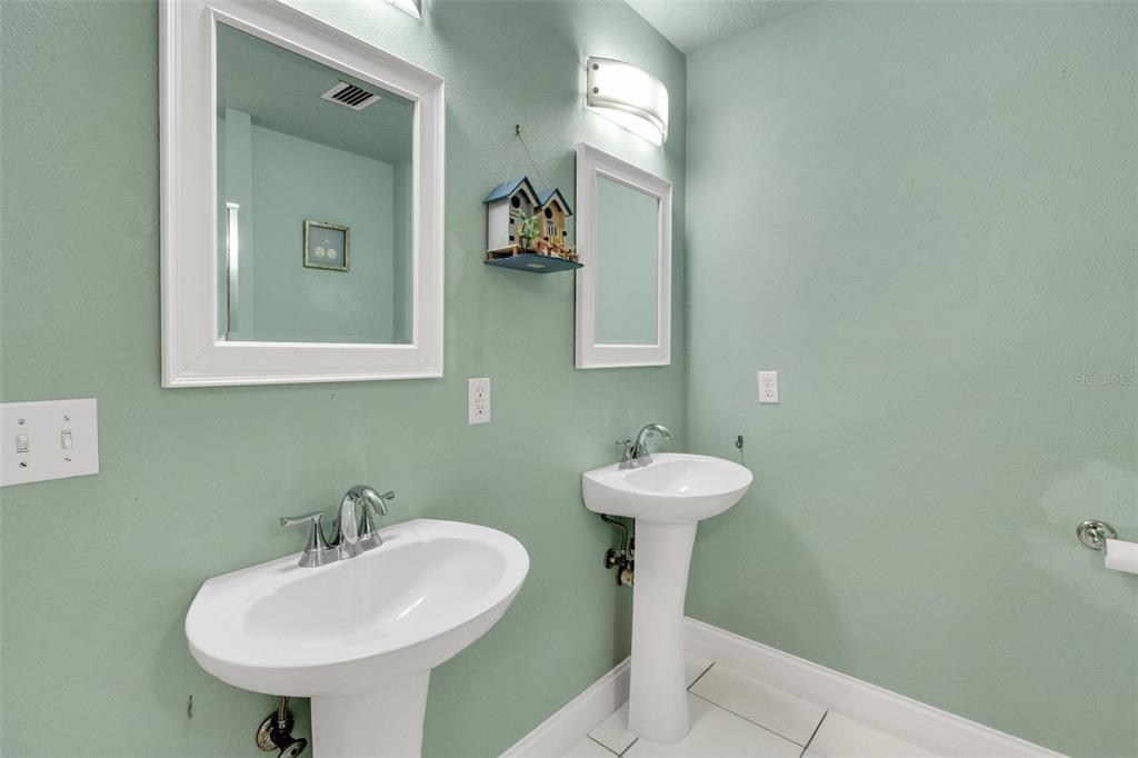 202 St Lucie Road Winter Haven, FL 33884 - Photo 20 of 32 a bathroom with a sink a mirror and toilet
