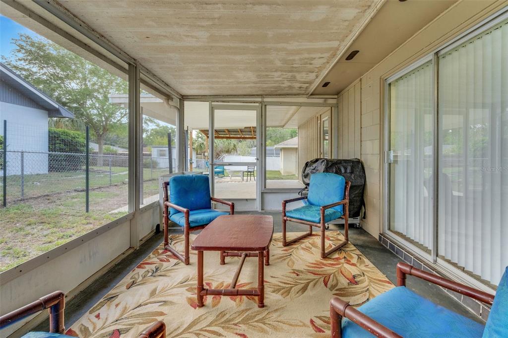 202 St Lucie Road Winter Haven, FL 33884 - Photo 23 of 32 a living room with furniture and a floor to ceiling window
