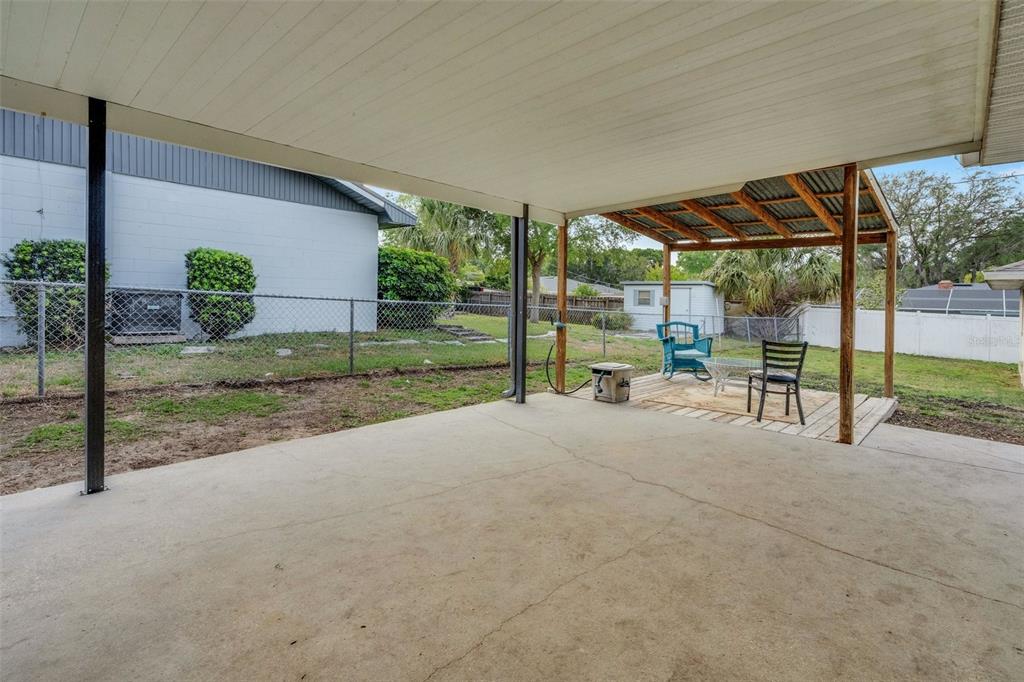 202 St Lucie Road Winter Haven, FL 33884 - Photo 24 of 32 a view of patio with table and chairs under an umbrella