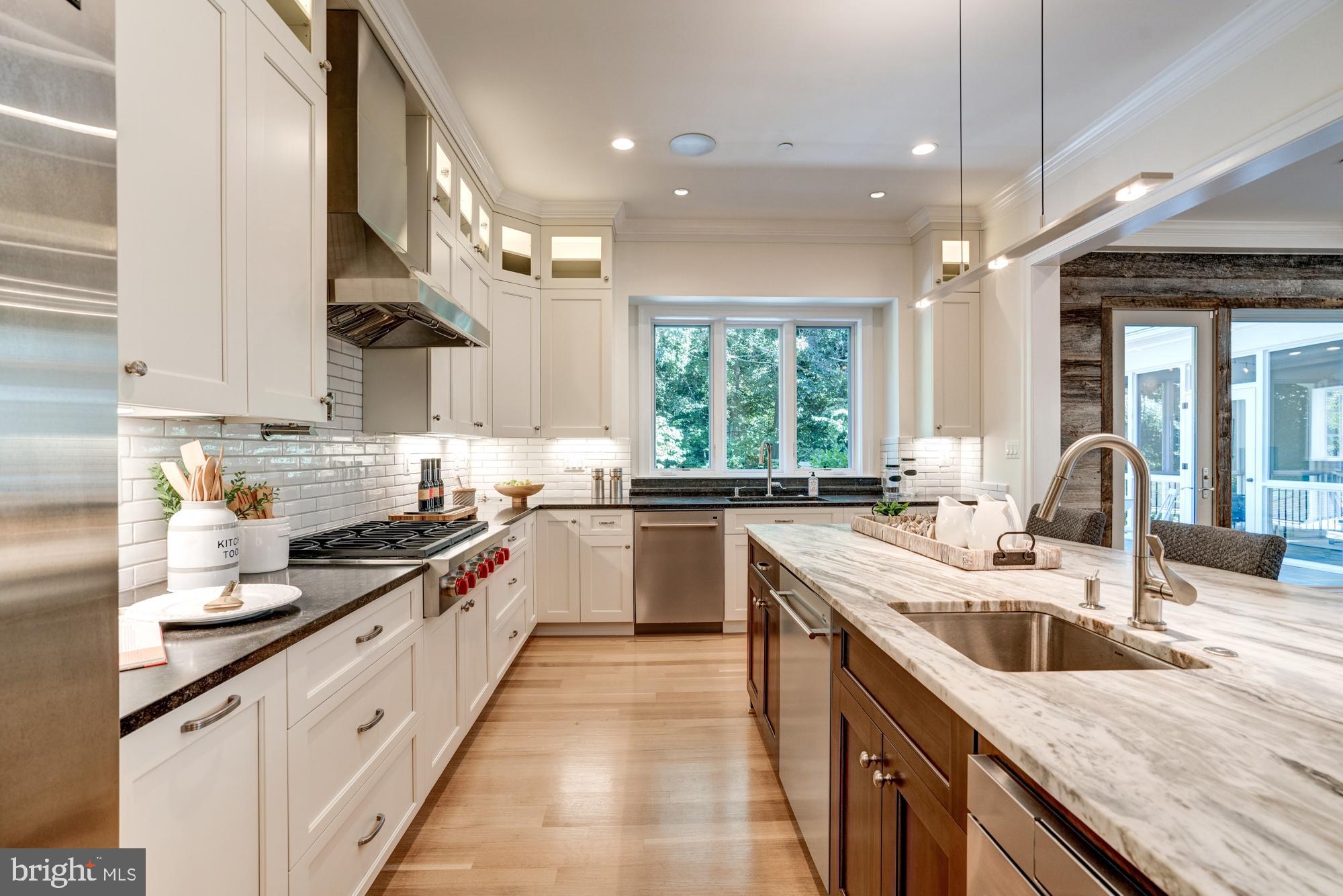 5607 Warwick Place Chevy Chase, MD 20815 - Photo 17 of 91 a kitchen with stainless steel appliances granite countertop sink stove and refrigerator