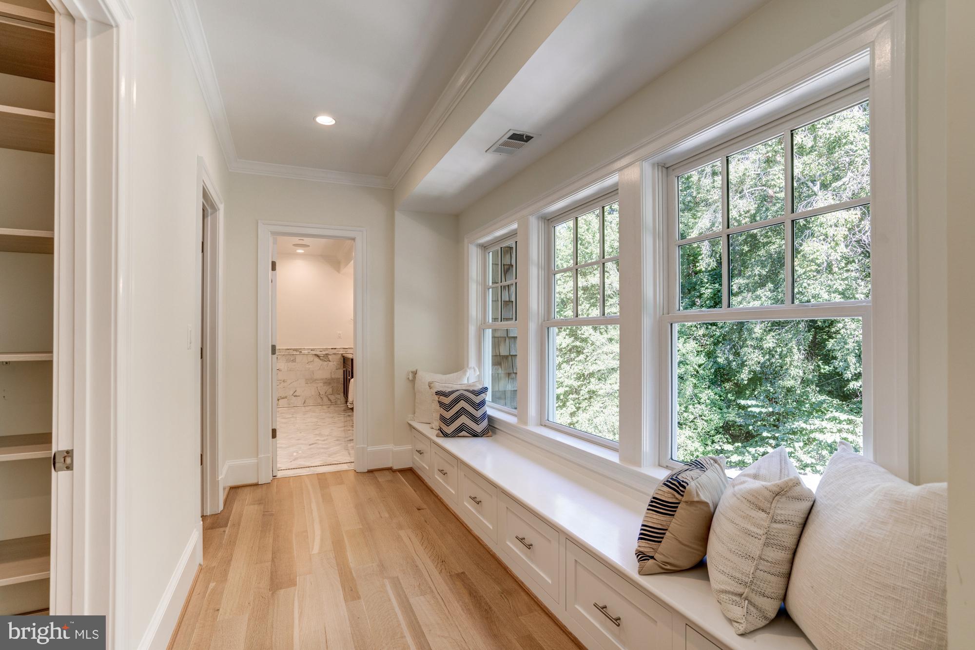 5607 Warwick Place Chevy Chase, MD 20815 - Photo 34 of 91 a spacious bedroom with a bed and a large window