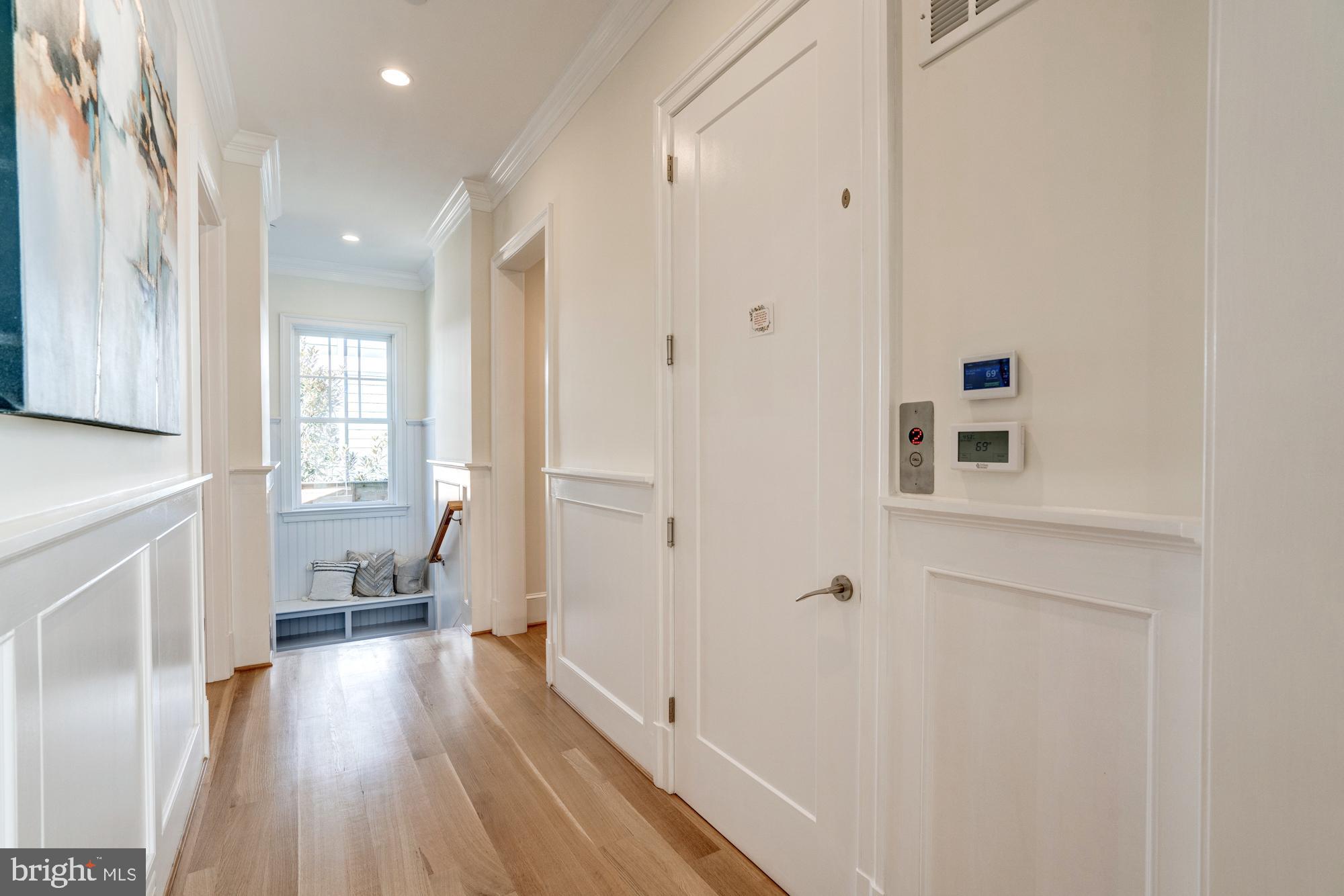 5607 Warwick Place Chevy Chase, MD 20815 - Photo 36 of 91 a view of a hallway with wooden floor and a living room