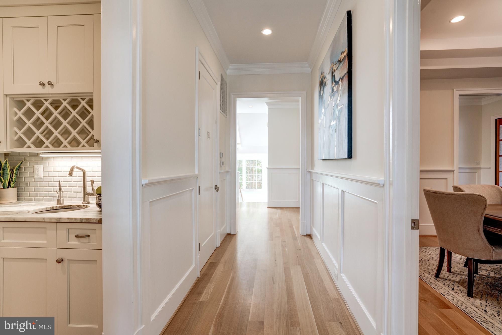 5607 Warwick Place Chevy Chase, MD 20815 - Photo 37 of 91 a view of a hallway with wooden floor and a bathroom