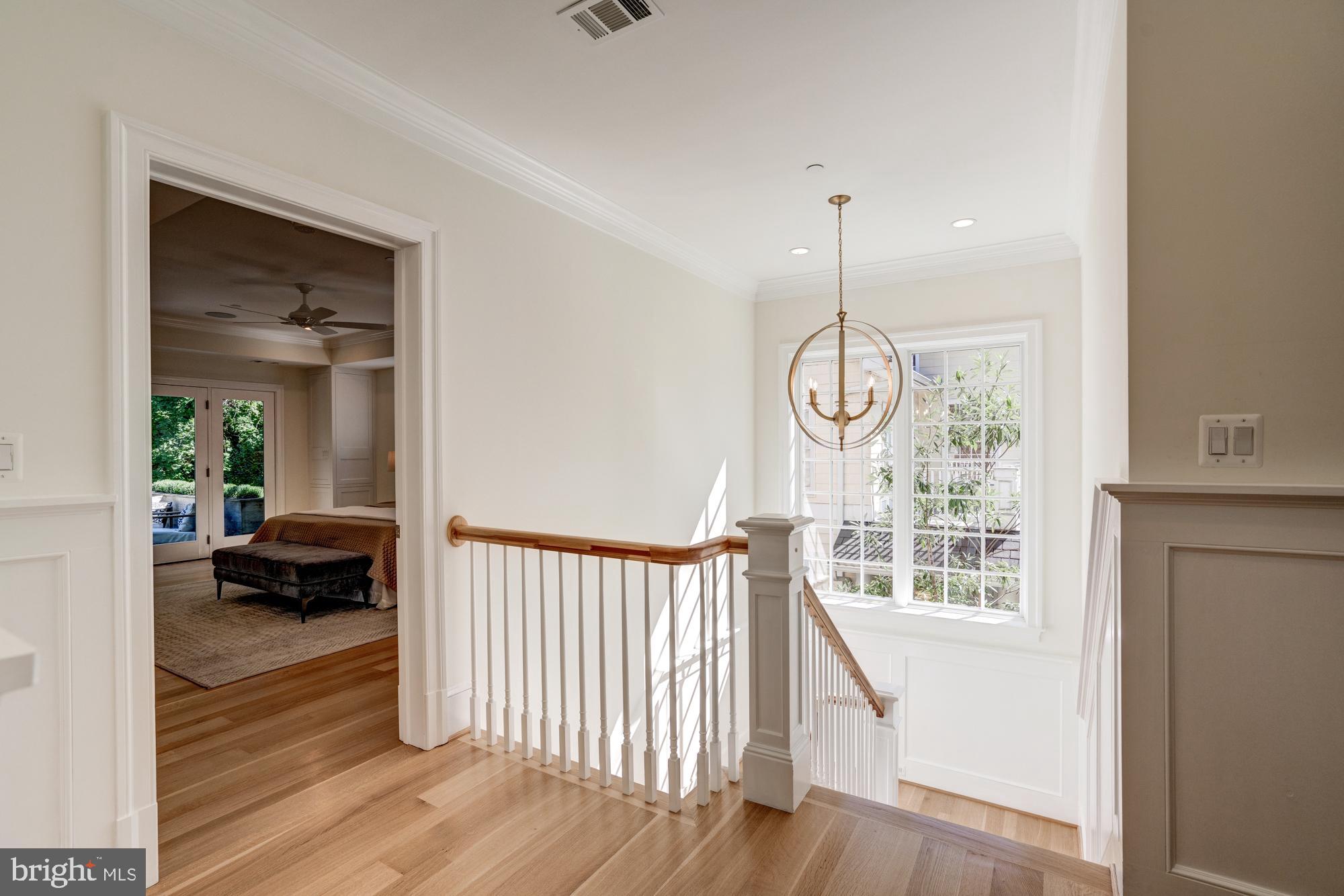 5607 Warwick Place Chevy Chase, MD 20815 - Photo 53 of 91 a view of a hallway with wooden floor and windows