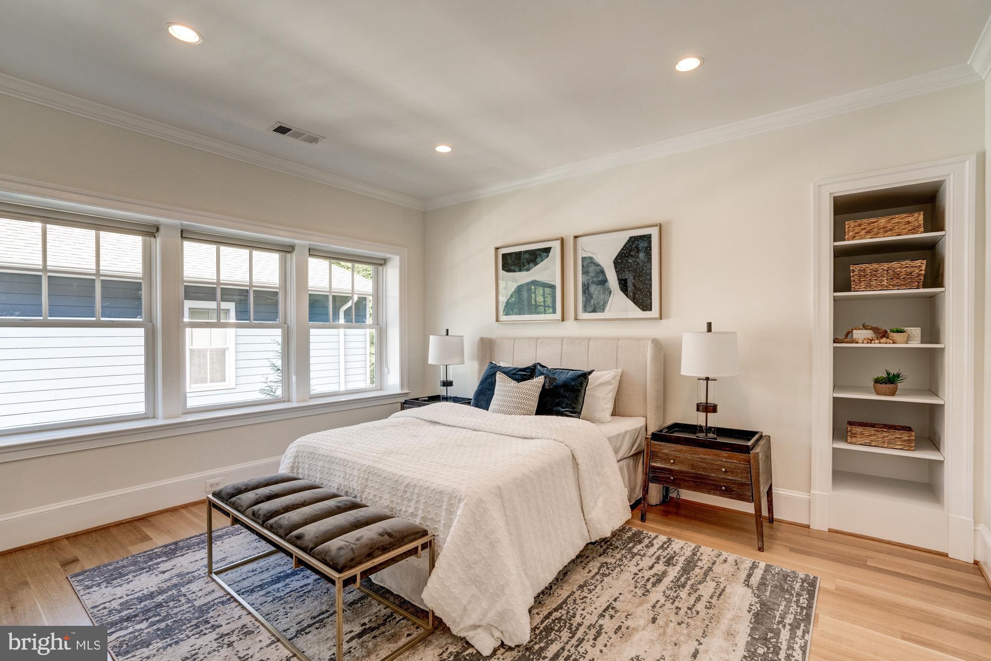5607 Warwick Place Chevy Chase, MD 20815 - Photo 63 of 91 a spacious bedroom with a bed and a window