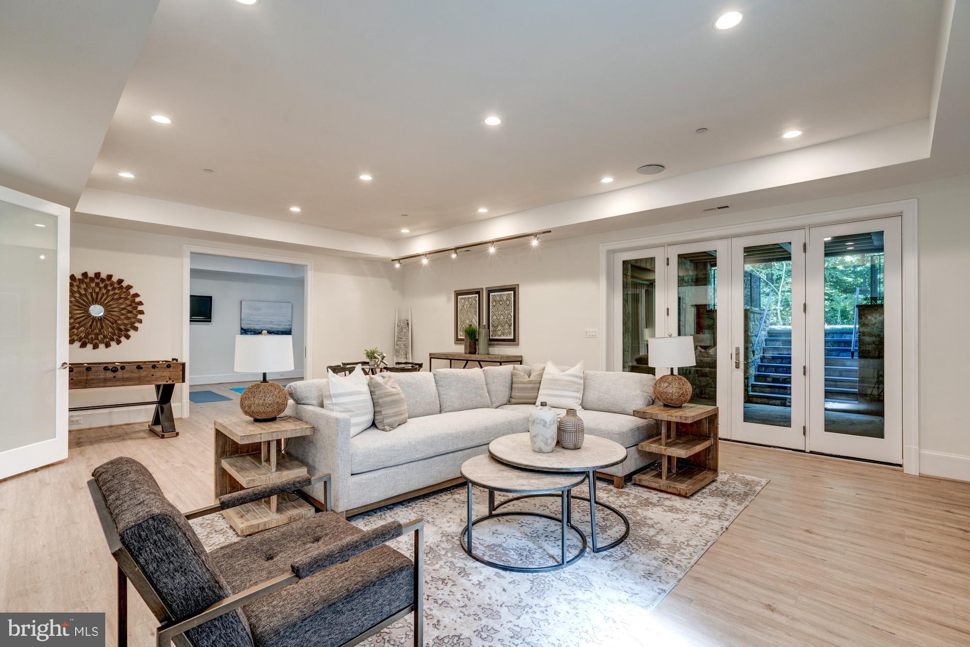 5607 Warwick Place Chevy Chase, MD 20815 - Photo 72 of 91 a living room with furniture kitchen view and large windows