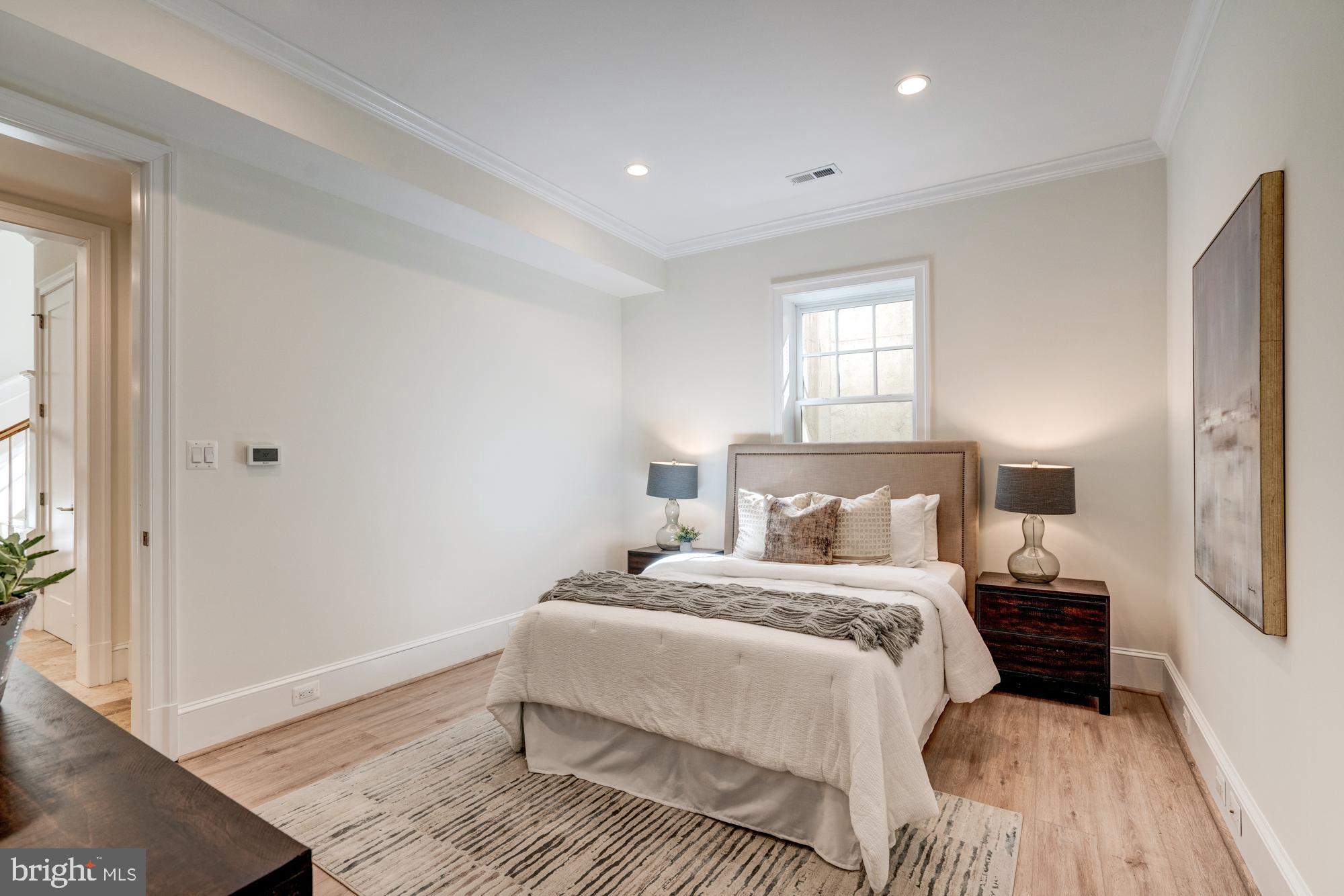 5607 Warwick Place Chevy Chase, MD 20815 - Photo 80 of 91 a bedroom with a bed and wooden floor