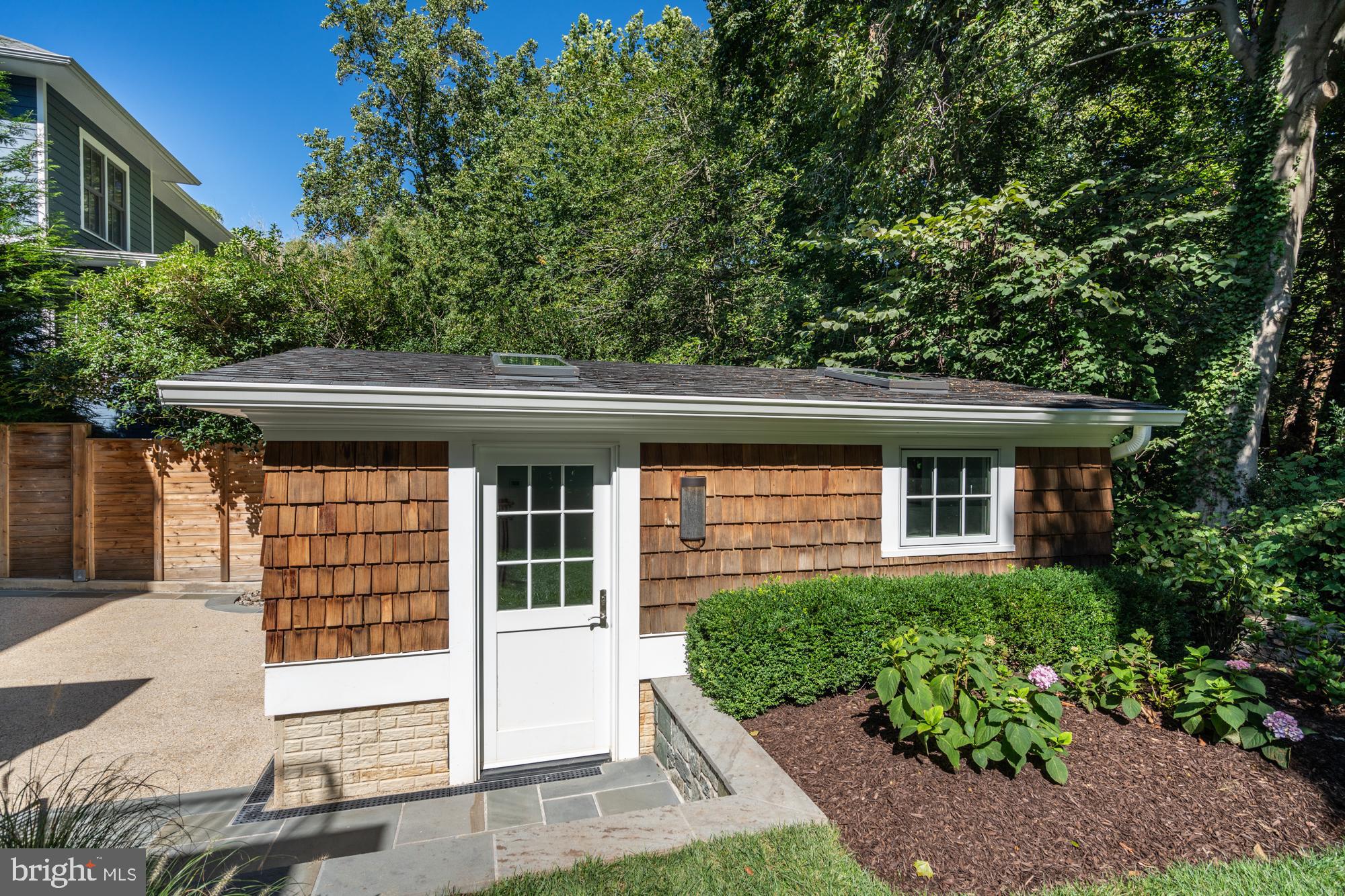 5607 Warwick Place Chevy Chase, MD 20815 - Photo 89 of 91 a front view of a house with a garden