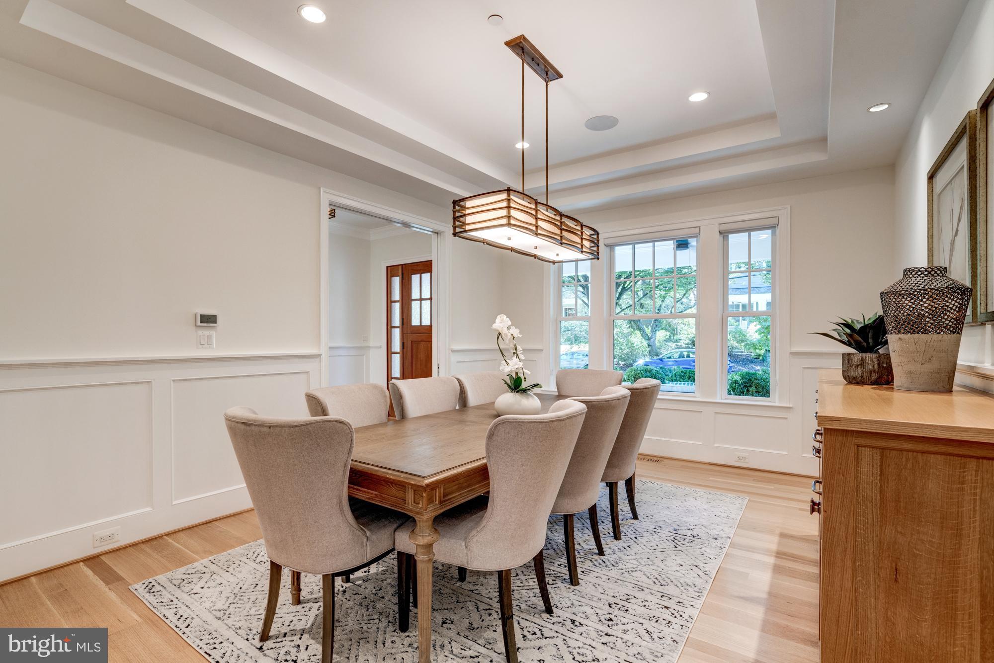 5607 Warwick Place Chevy Chase, MD 20815 - Photo 10 of 91 a dining room with furniture a chandelier and wooden floor