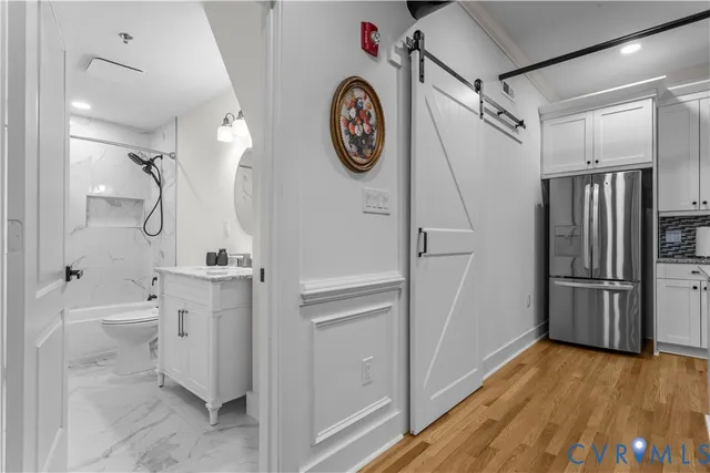 a kitchen with stainless steel appliances granite countertop a sink and a refrigerator