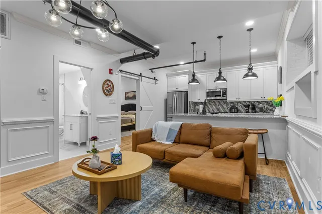 a kitchen with kitchen island granite countertop a sink a center island and stainless steel appliances