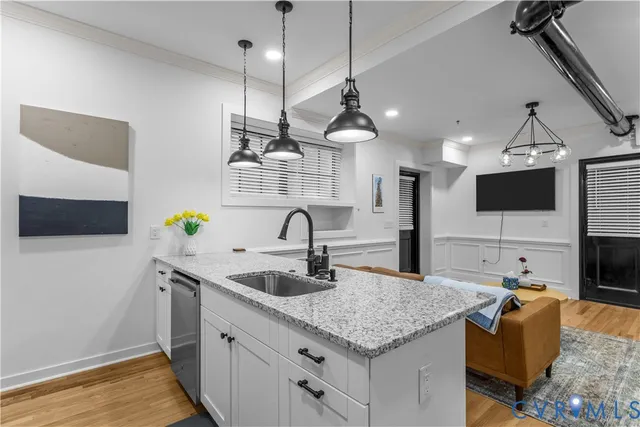 a kitchen with granite countertop a sink stove and refrigerator