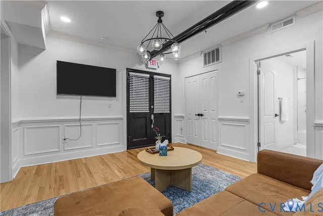 a living room with furniture and a wooden floor