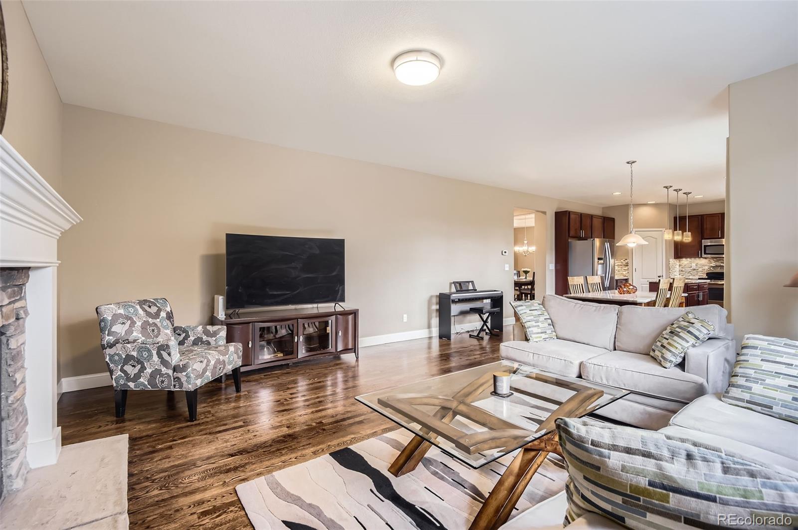 14110 Greenfield Loop Parker, CO 80134 - Photo 16 of 47 a living room with furniture and a flat screen tv