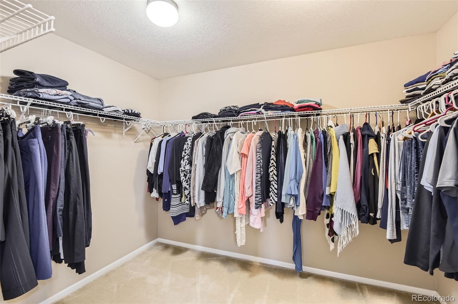 14110 Greenfield Loop Parker, CO 80134 - Photo 20 of 47 a view of walk in closet with clothes