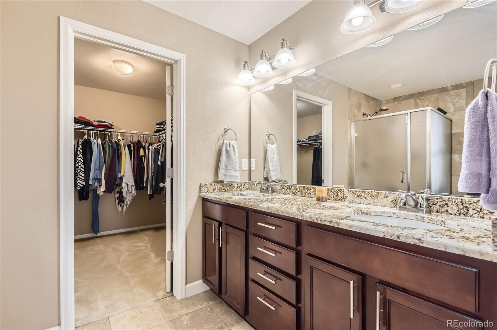 14110 Greenfield Loop Parker, CO 80134 - Photo 22 of 47 a bathroom with a sink vanity and a mirror