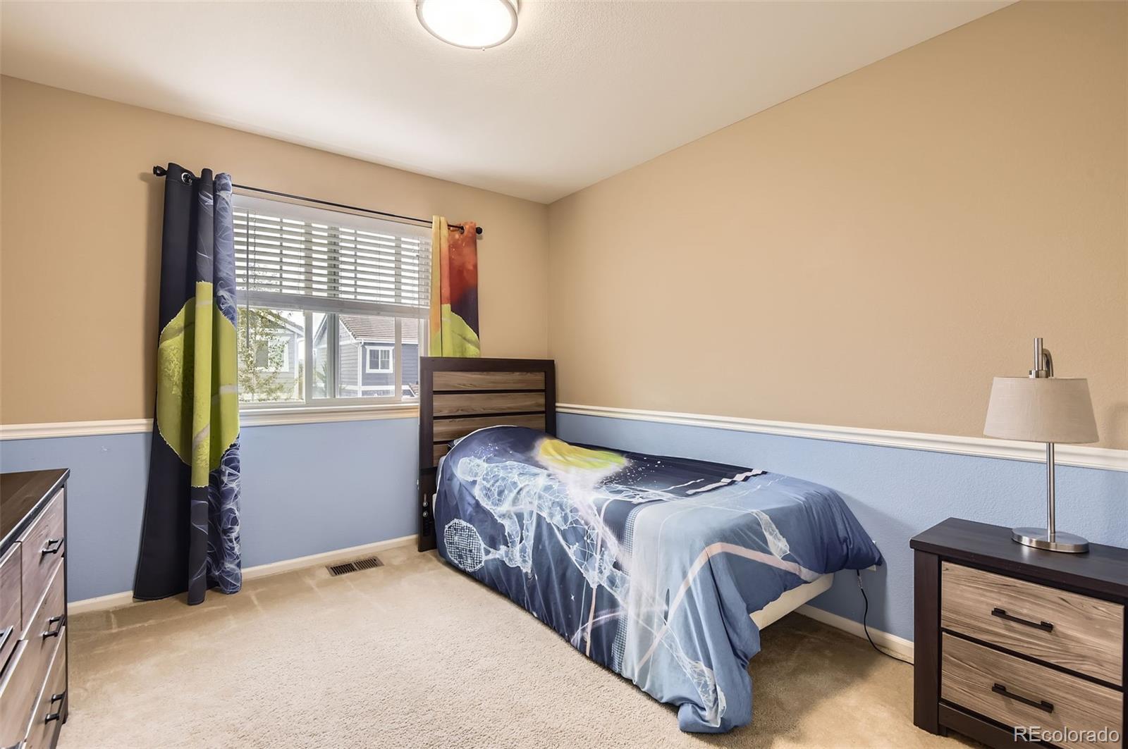 14110 Greenfield Loop Parker, CO 80134 - Photo 23 of 47 a bedroom with a bed and a window