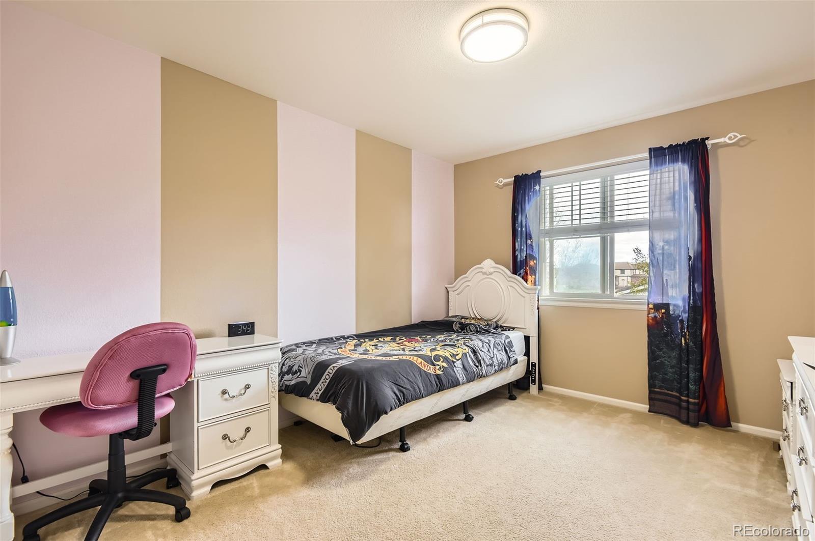 14110 Greenfield Loop Parker, CO 80134 - Photo 25 of 47 a bedroom with a bed and a window