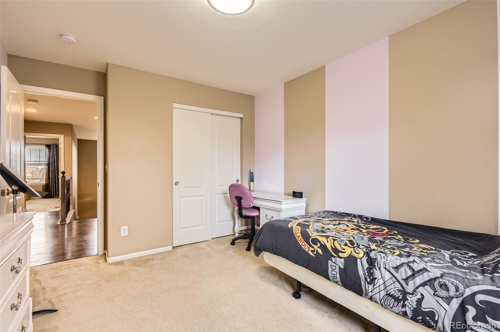 14110 Greenfield Loop Parker, CO 80134 - Photo 26 of 47 a bed room with a bed and a chair