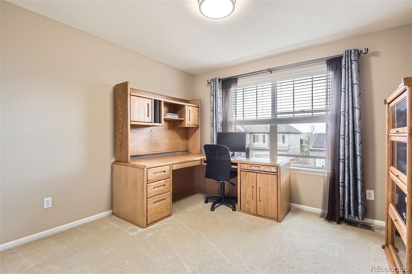 14110 Greenfield Loop Parker, CO 80134 - Photo 29 of 47 a room with furniture a flat screen tv and large window