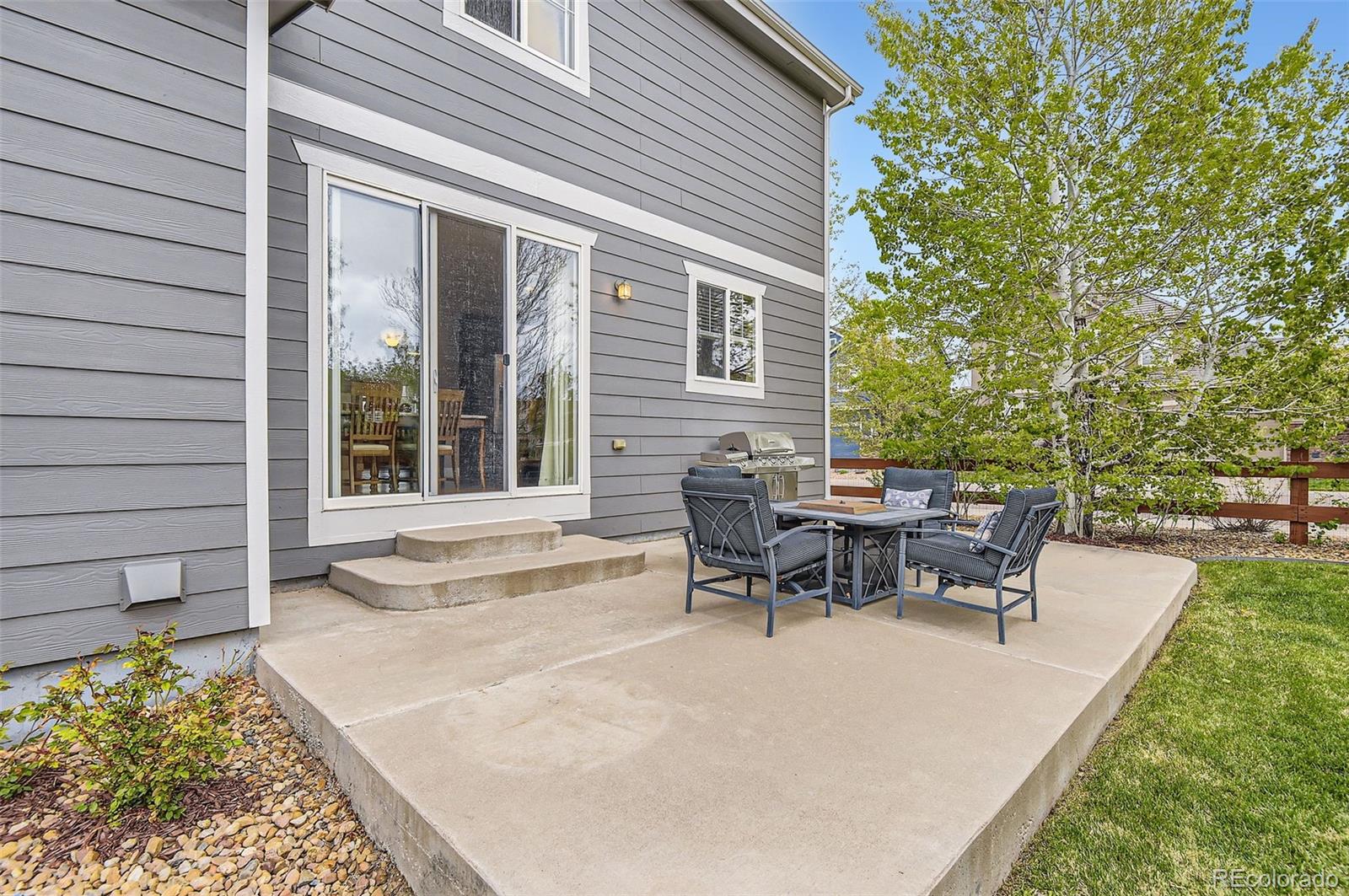 14110 Greenfield Loop Parker, CO 80134 - Photo 35 of 47 a view of a house with patio and a yard