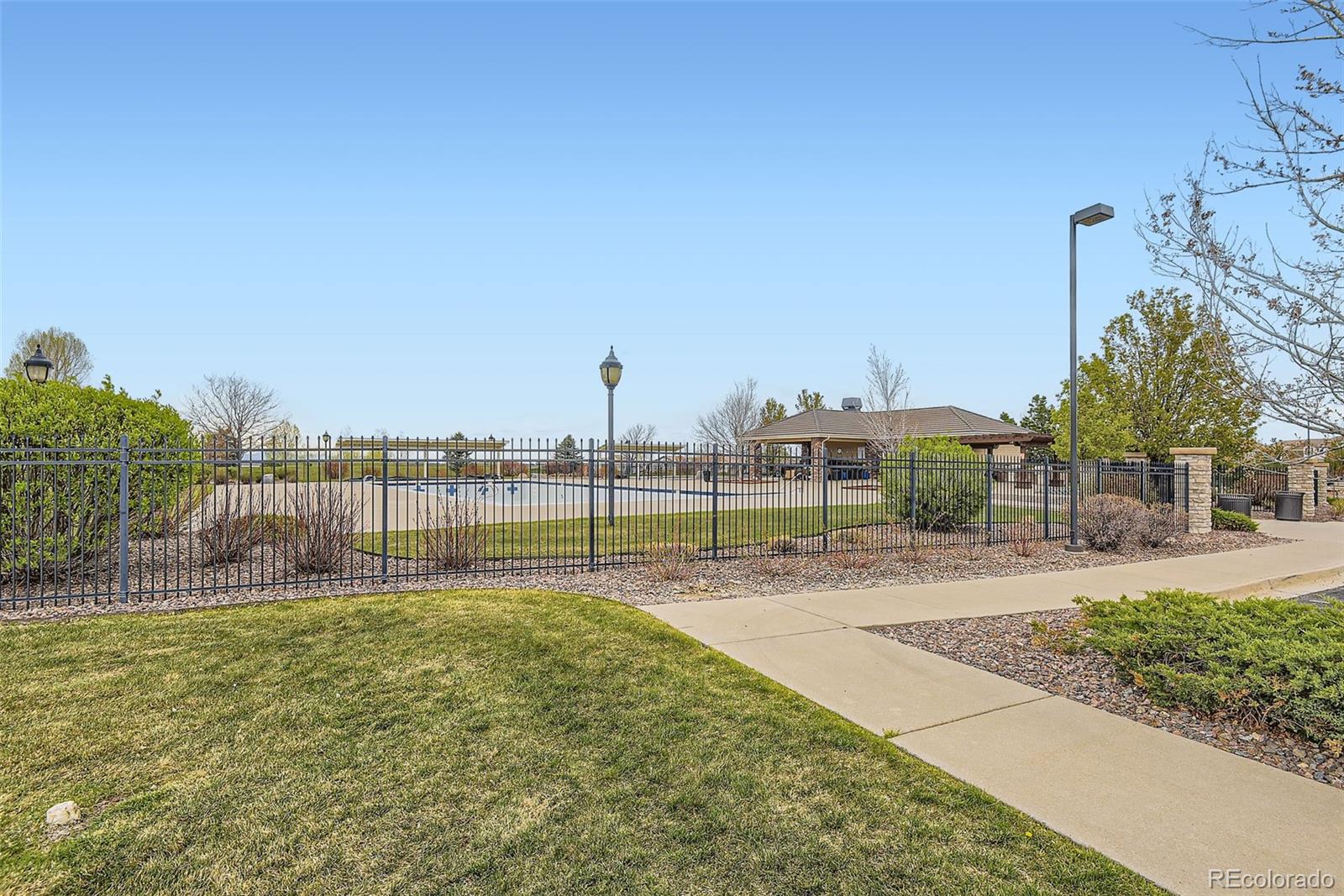 14110 Greenfield Loop Parker, CO 80134 - Photo 38 of 47 a swimming pool with a yard